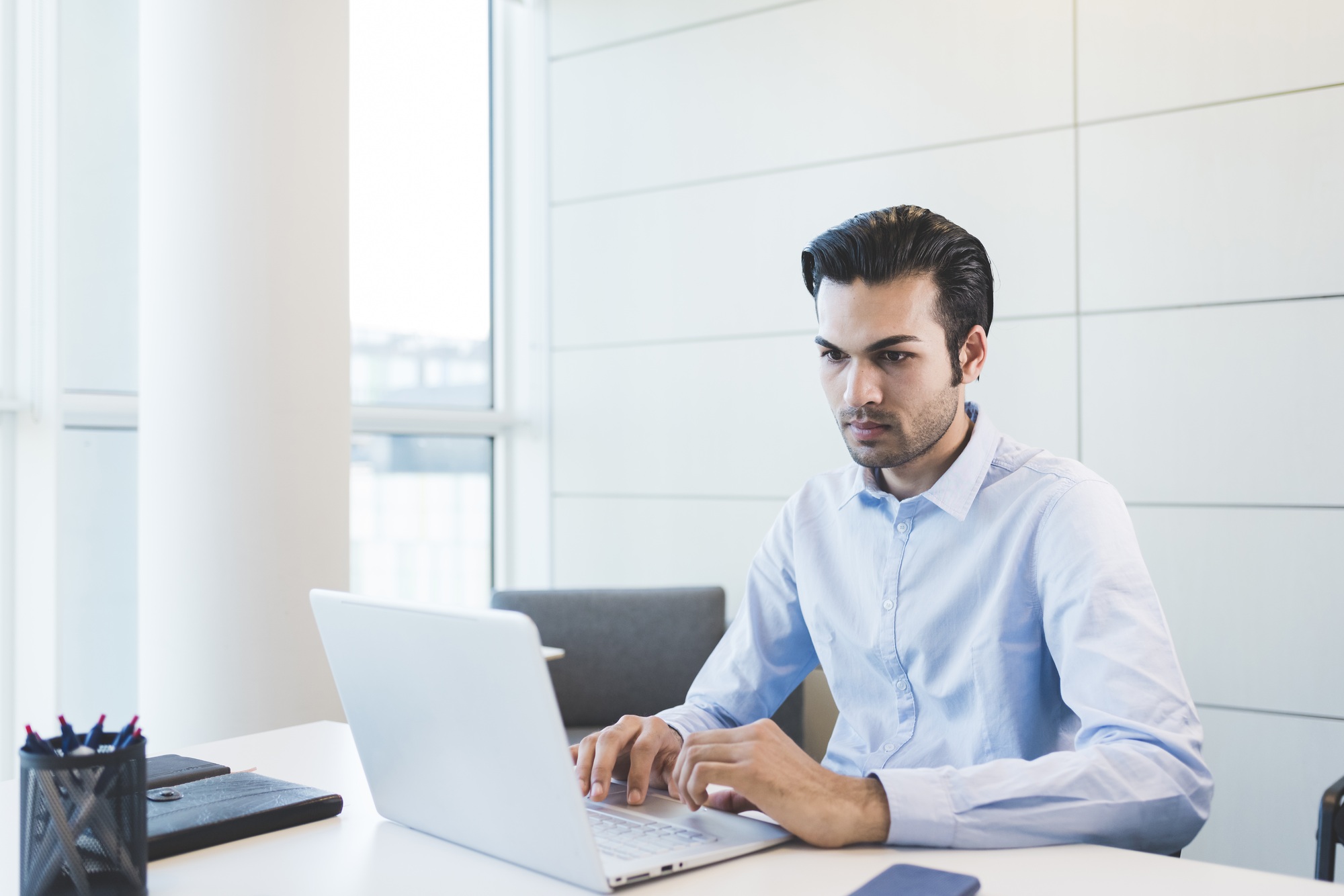 Young indian businessman using computer